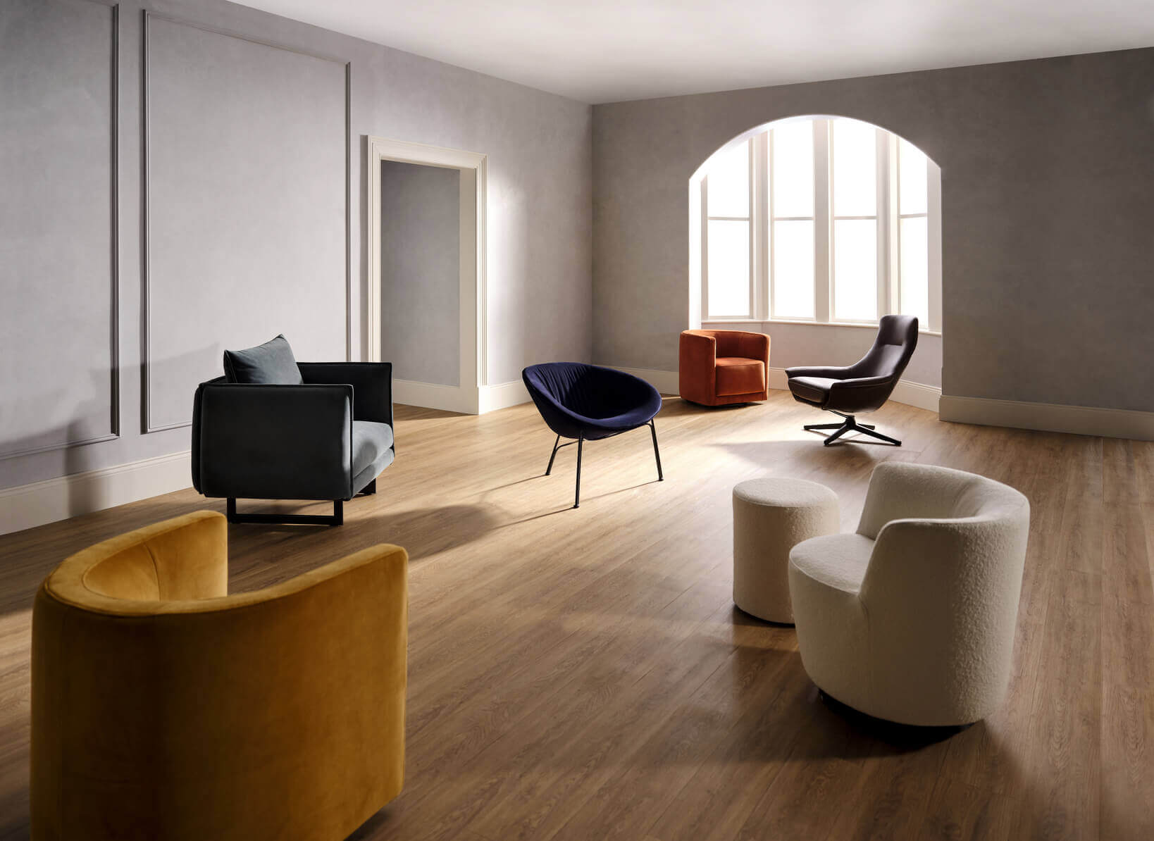 A studio shoot setting on six differently styled and coloured King Living reading chairs, all backed by the King Living 25 Year Steel Frame Warranty.