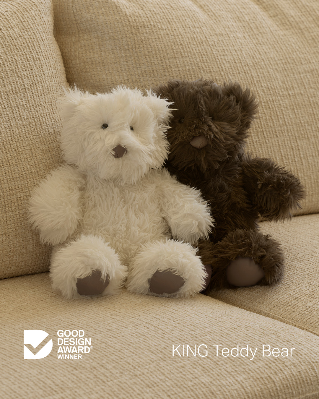 Two cuddly teddy bears on a sofa in light neutral and chocolate brown. The perfect plush addition to a child’s bedroom or playroom.
