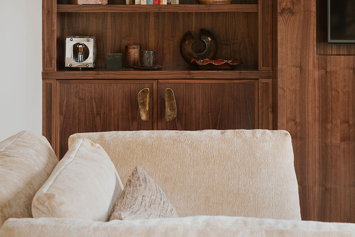 Large lounge chair with adjustable arms for comfort styled in a warm neutral velvet fabric.