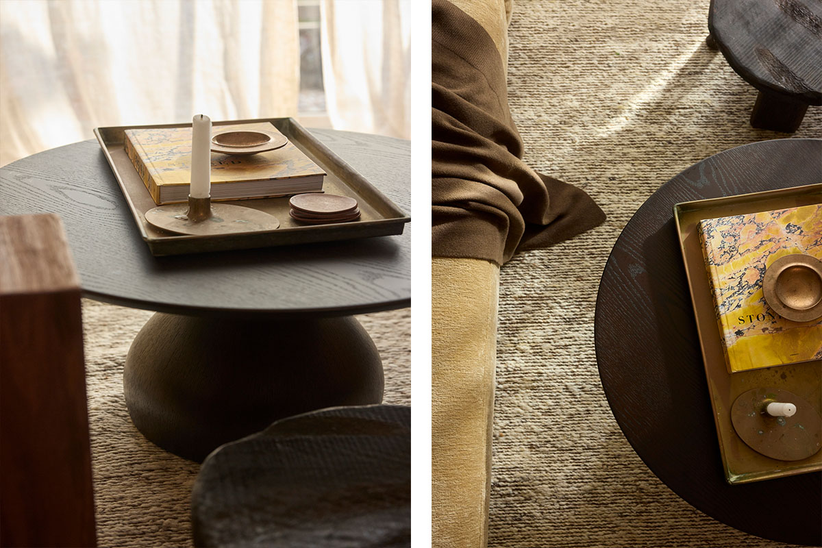 A dark timber round coffee table styled with a textured rug, ideal for small living room ideas.