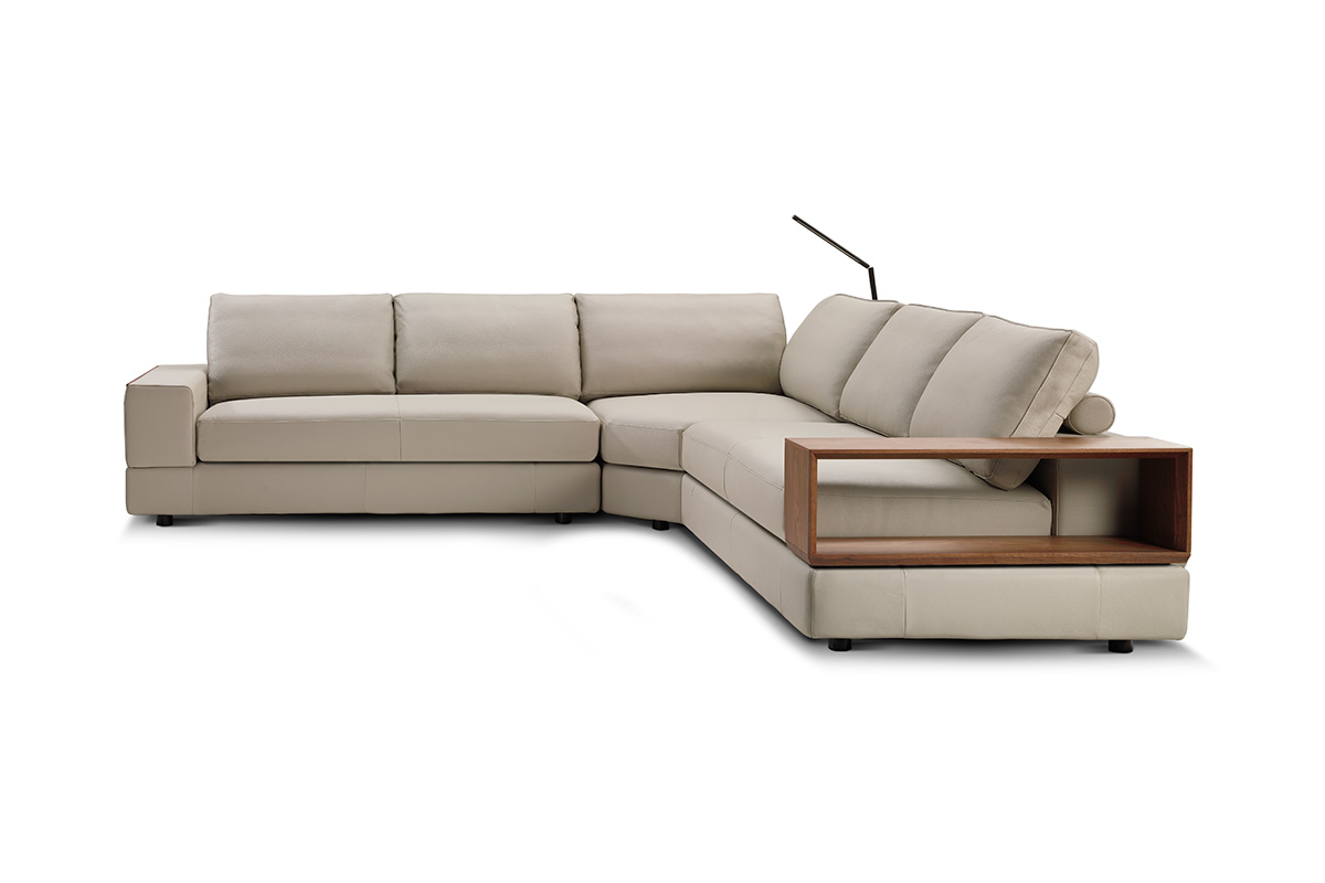 Modular sofa with timber shelf, styled in a light neutral fabric with a smart accessory LED reading lamp.