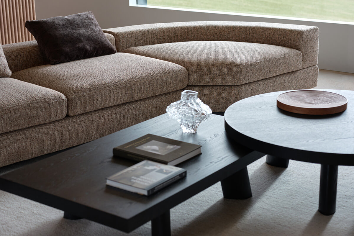 Two seasonal stylings of a modular sofa in natural fabric, a light neutral weave (above) and a deeper truffle weave (below).